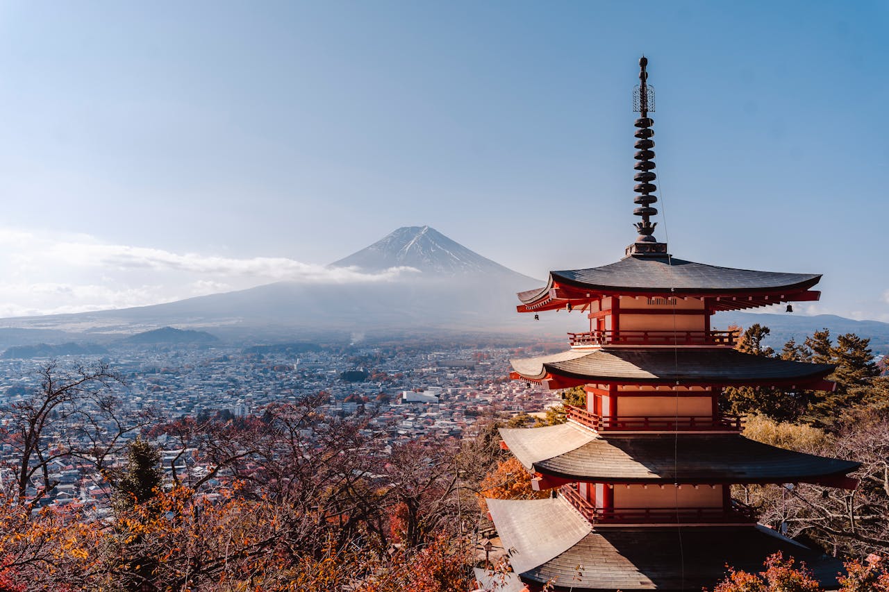 The Chureito Pagoda overlooking Fujiyoshida city with Mount Fuji in the background during autumn in Japan.